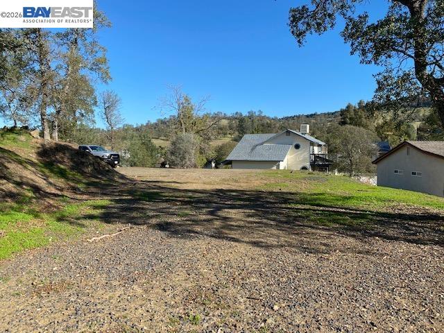 512 Winchester Way Copperopolis, CA 95228 - Photo 7 of 11 a view of a house with a yard