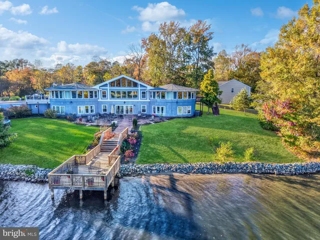 a view of a chairs in a yard with wooden fence
