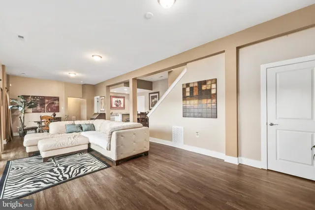 a bed sitting in a spacious bedroom next to a window and a larger closet