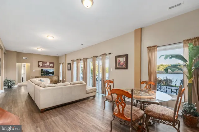 a bedroom with a large bed and a painting on the wall