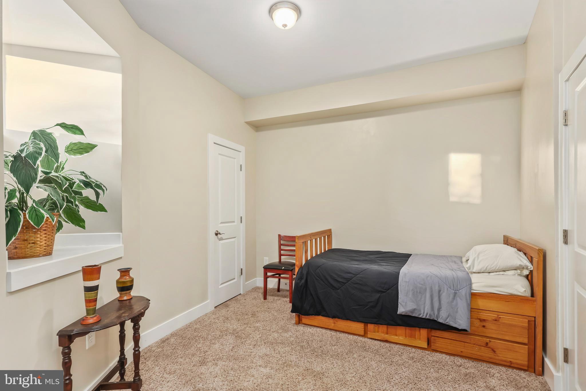 20 Greenvale Court Ruther Glen, VA 22546 - Photo 41 of 65 a bedroom with a bed and a potted plant