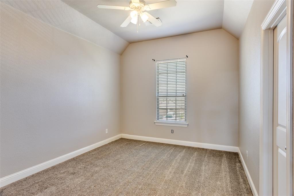 1505 5th Street Argyle, TX 76226 - Photo 22 of 25 an empty room with a chandelier fan and windows