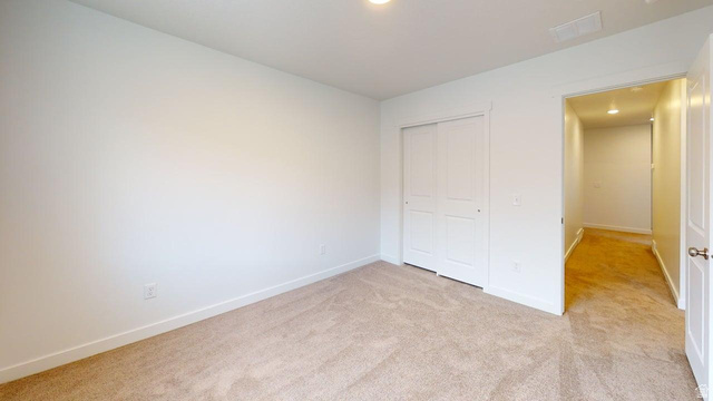 783 Pheasantbrook Drive, Unit 2A Centerville, UT 84014 - Photo 21 of 41 Carpeted room with white walls, baseboards, and a sliding closet door