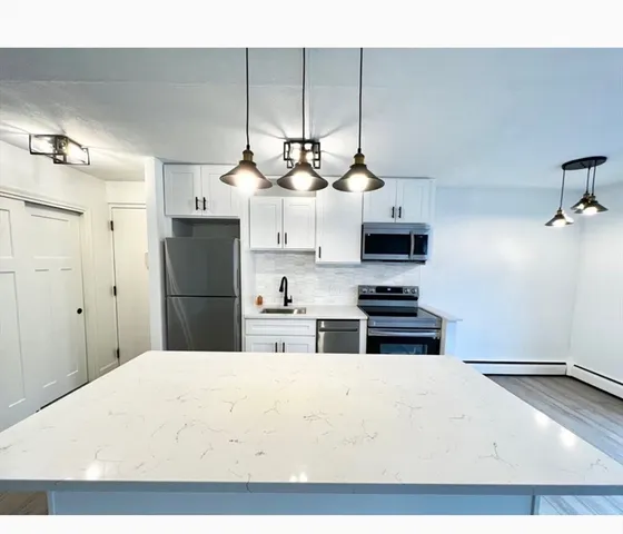 a kitchen with stainless steel appliances a refrigerator and a stove