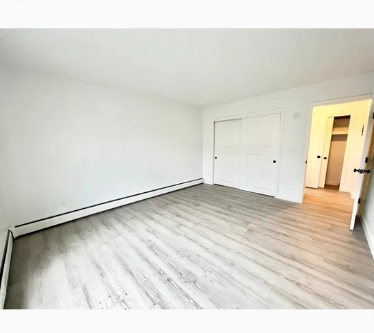 a view of an empty room and wooden floor