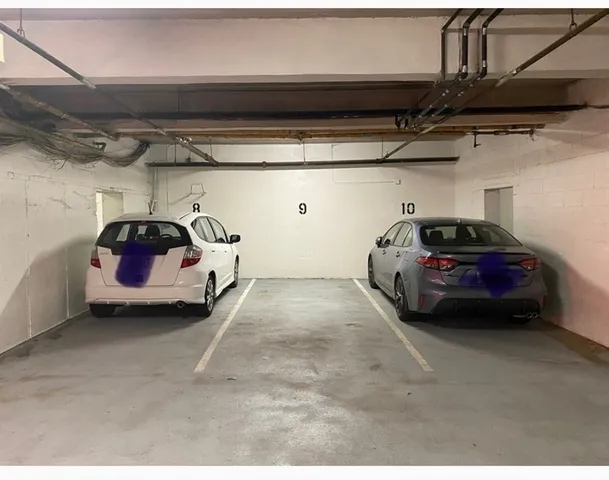 a view of garage with cars