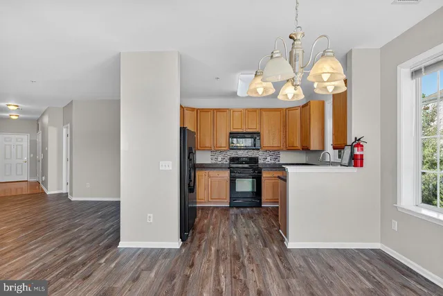a view of a kitchen and dining room with wooden floor