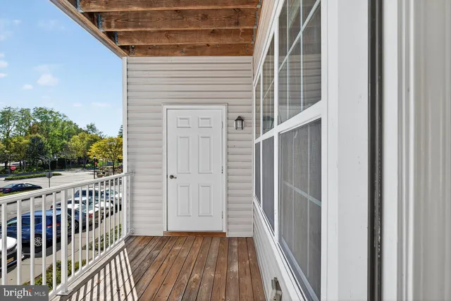 a view of a porch with wooden floor and fence
