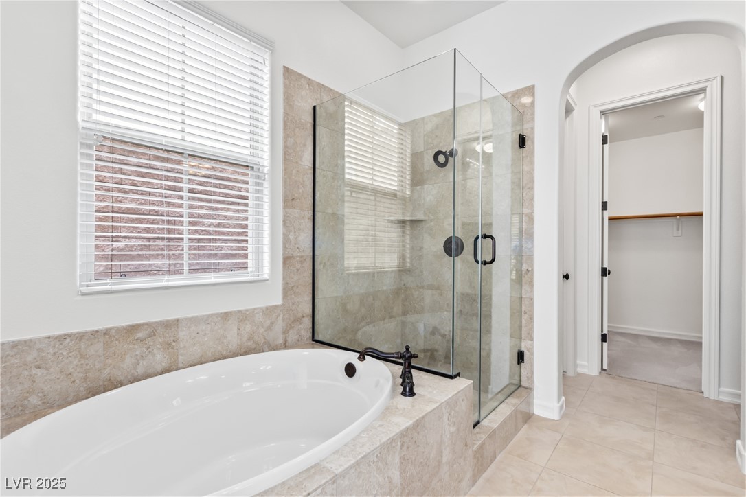 58 Contrada Fiore Drive Henderson, NV 89011 - Photo 24 of 56 Bathroom featuring a walk in closet, a stall shower, a bath, and tile patterned floors
