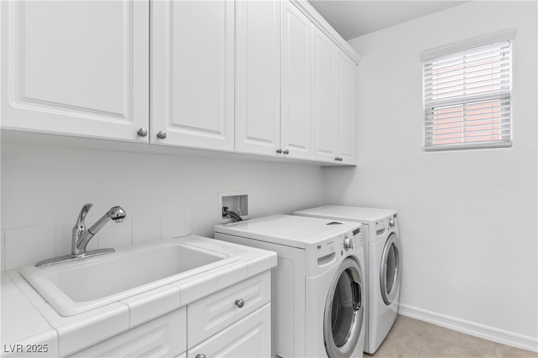 58 Contrada Fiore Drive Henderson, NV 89011 - Photo 26 of 56 Laundry room featuring cabinet space, washing machine and dryer, and light tile patterned floors