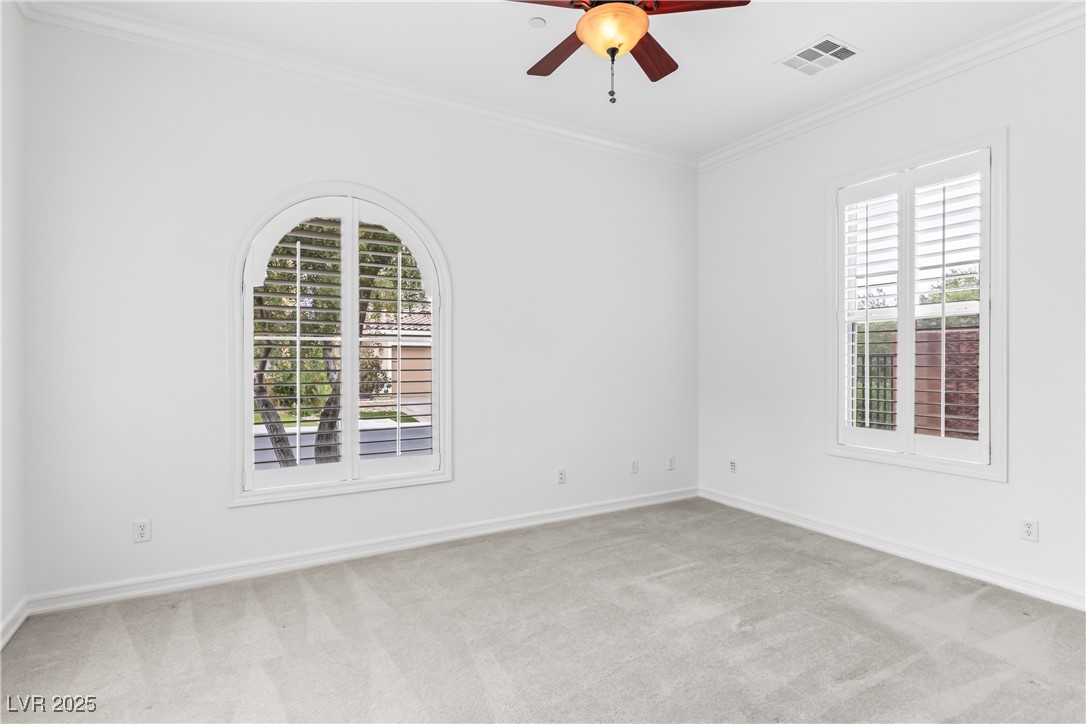 58 Contrada Fiore Drive Henderson, NV 89011 - Photo 27 of 56 Spare room featuring light colored carpet, ornamental molding, and ceiling fan