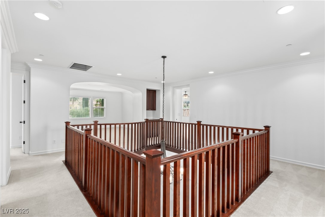 58 Contrada Fiore Drive Henderson, NV 89011 - Photo 32 of 56 Corridor featuring light carpet, an upstairs landing, ornamental molding, and recessed lighting