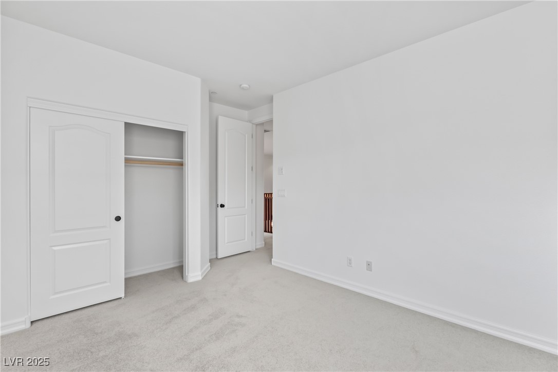 58 Contrada Fiore Drive Henderson, NV 89011 - Photo 39 of 56 Unfurnished bedroom featuring light colored carpet and a closet