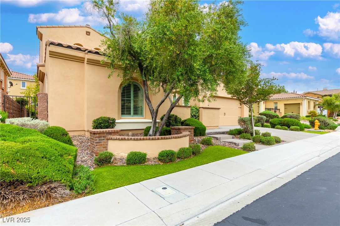 58 Contrada Fiore Drive Henderson, NV 89011 - Photo 56 of 56 Mediterranean / spanish house with stucco siding, a residential view, concrete driveway, and an attached garage