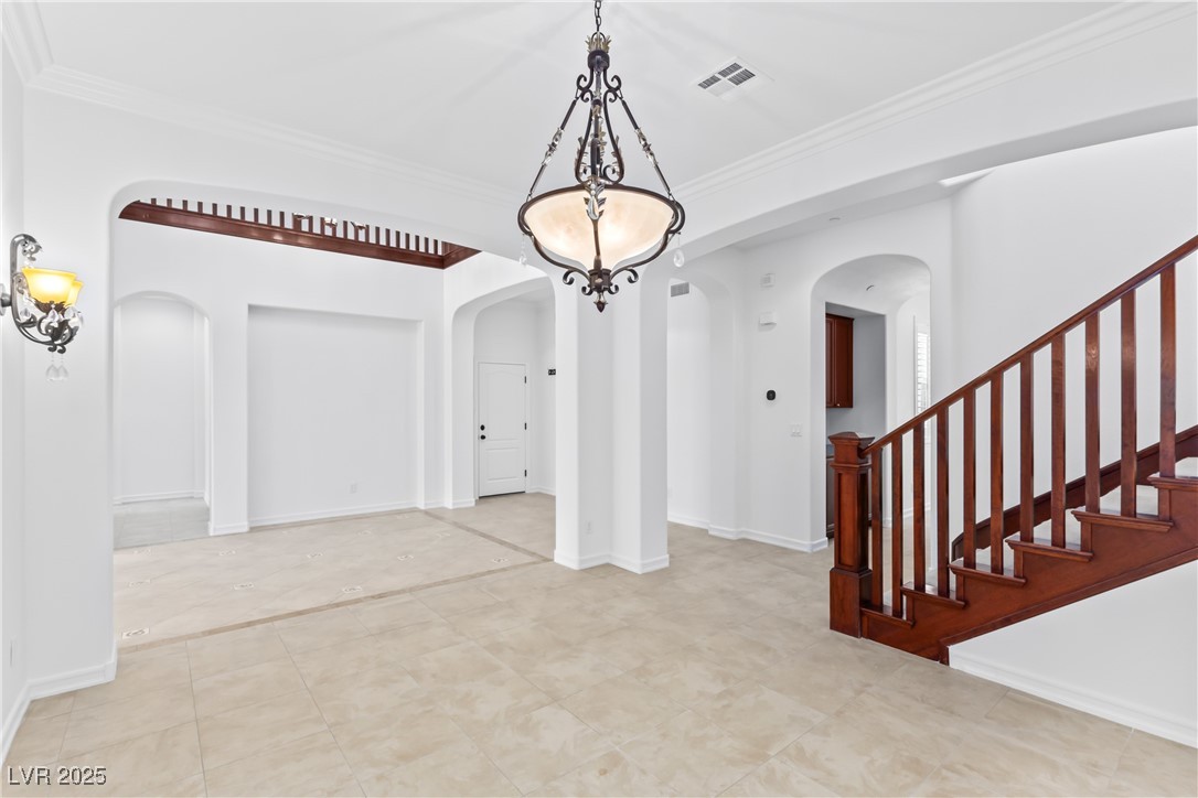 58 Contrada Fiore Drive Henderson, NV 89011 - Photo 9 of 56 Unfurnished dining area featuring ornamental molding and stairs