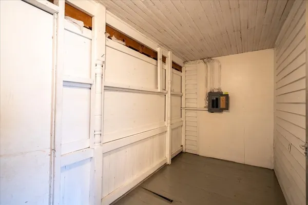 a view of storage and utility room with refrigerator