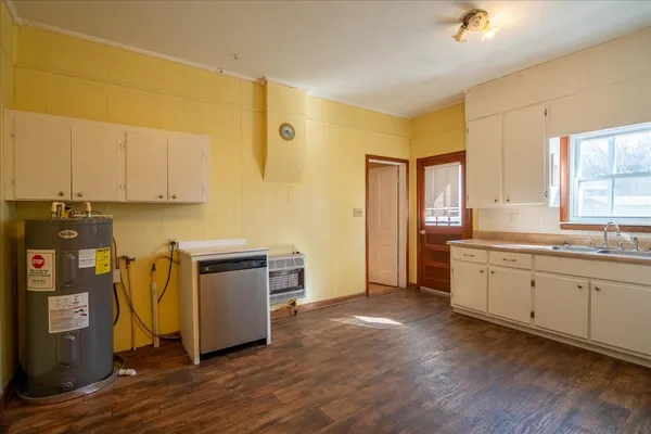 an empty room with wooden floor and closet