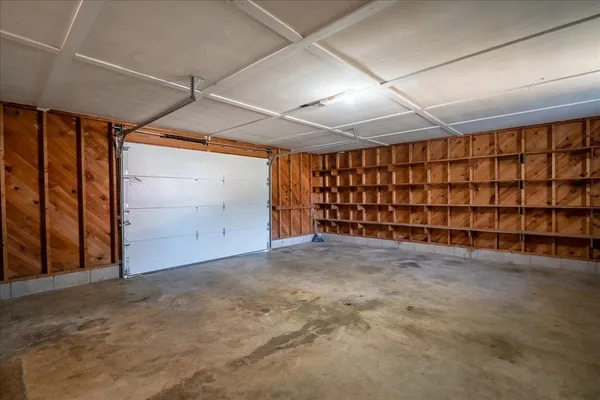 a view of a room with a ceiling fan wooden floor and a ceiling fan
