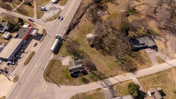 an aerial view of a house with a yard