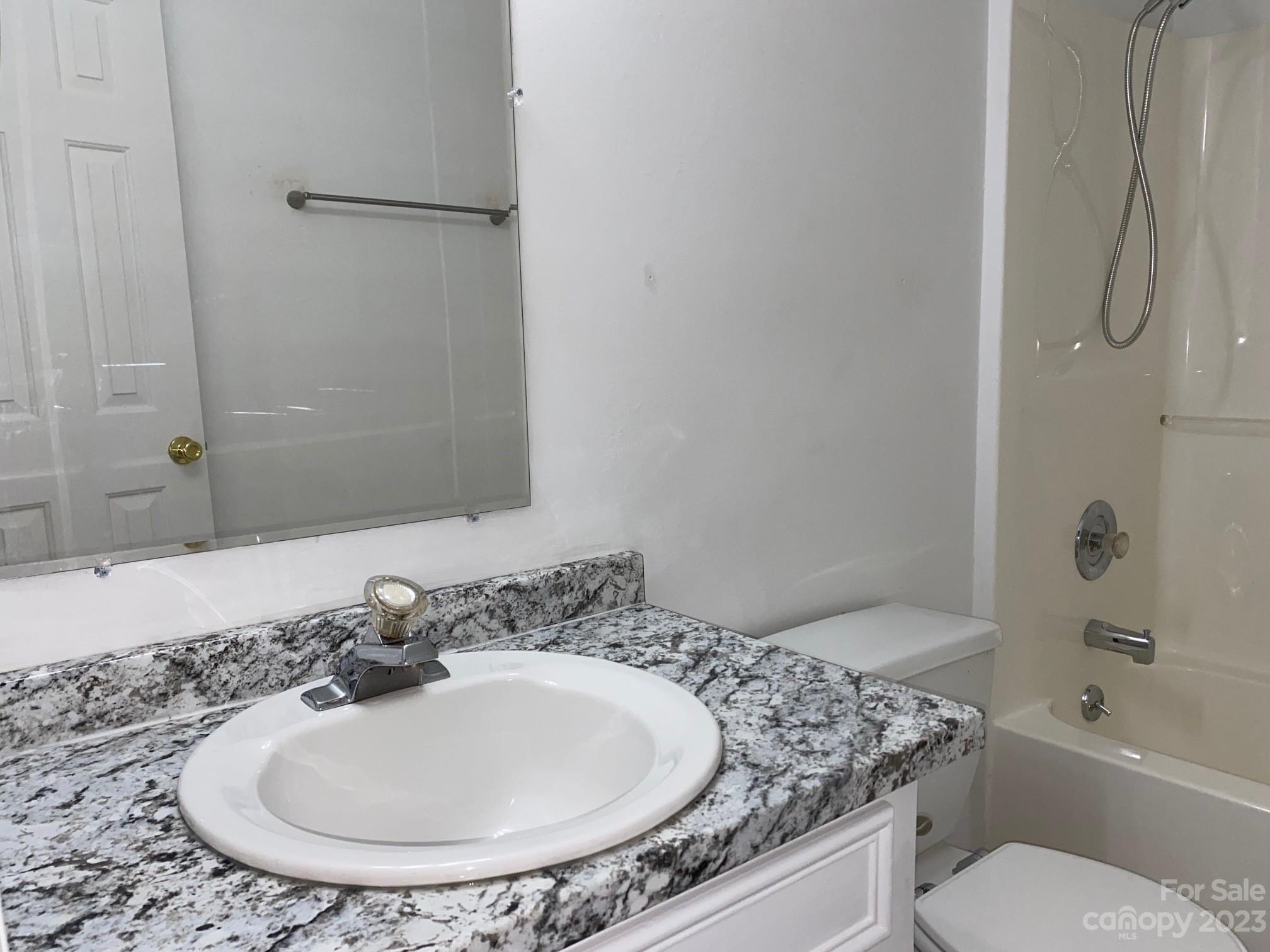 671 Pine Ridge Road Chester, SC 29706 - Photo 7 of 21 a bathroom with a granite countertop sink a toilet and shower