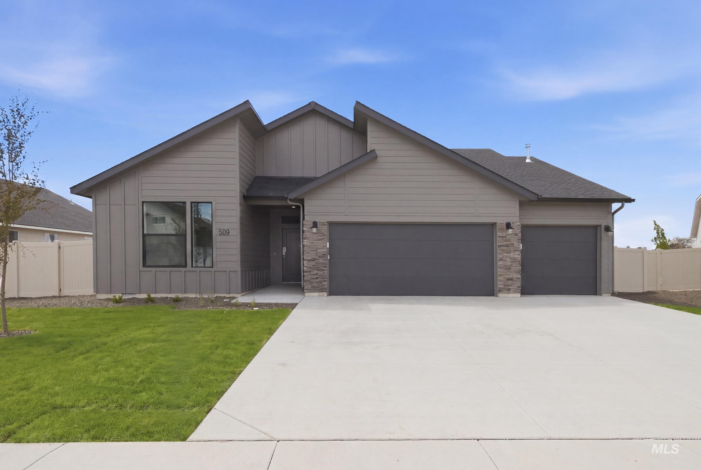 Contemporary exterior featuring a split-pitch roofline, vertical and horizontal siding, and stone accents