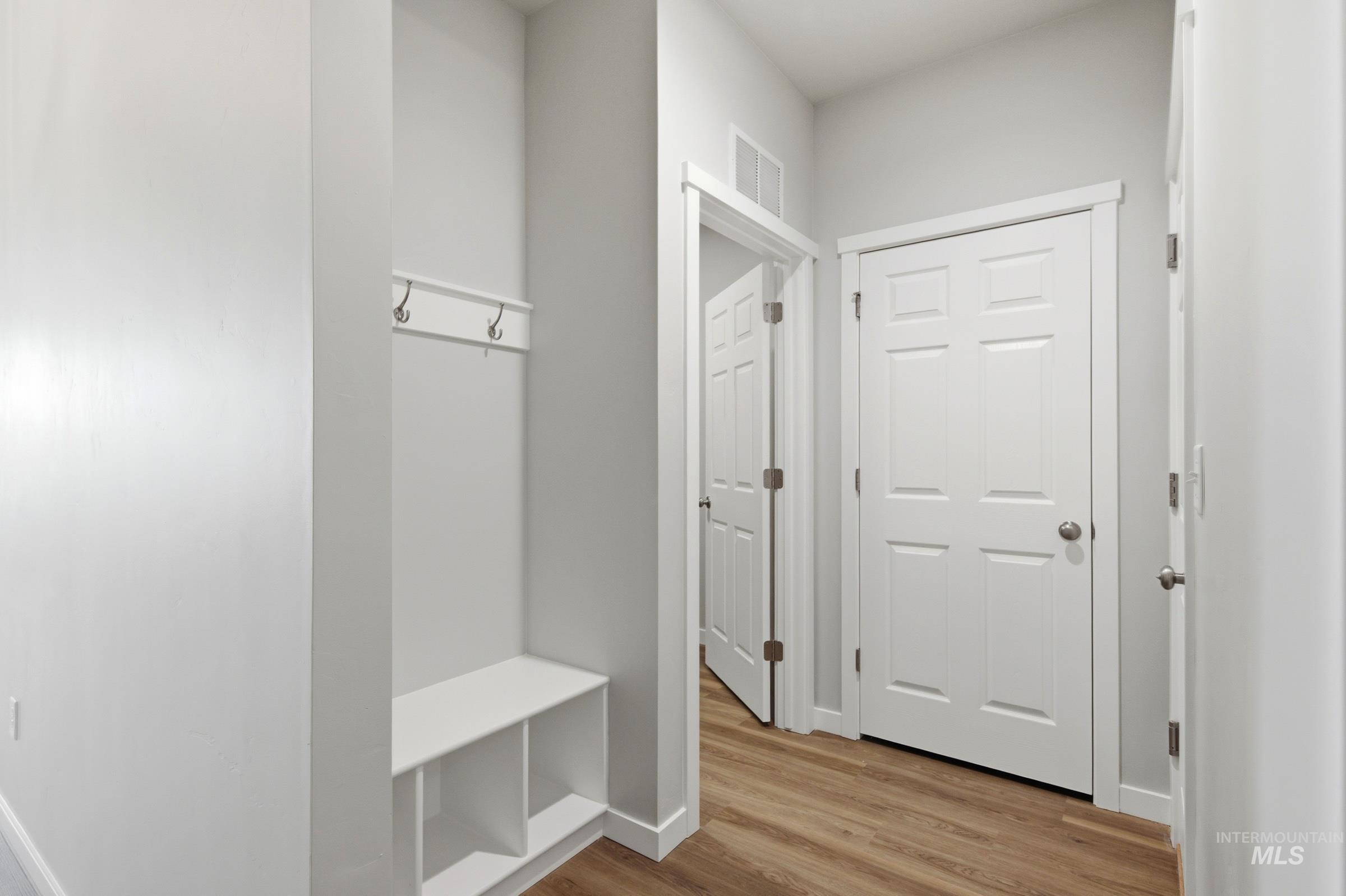 509 Waverly Avenue Middleton, ID 83644 - Photo 14 of 19 Entryway featuring a built-in bench, coat hooks, and wood-finish flooring
