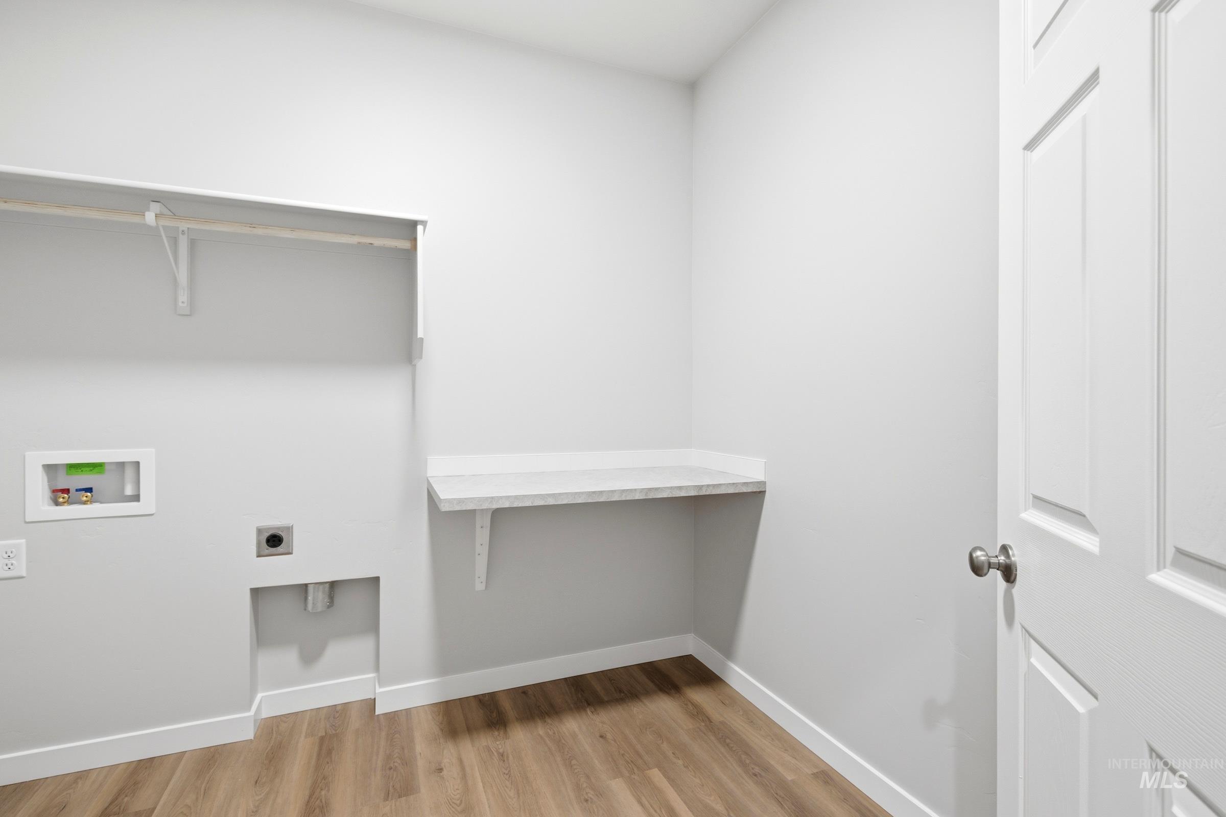 509 Waverly Avenue Middleton, ID 83644 - Photo 15 of 19 Dedicated laundry area featuring wood-finish flooring and light gray walls