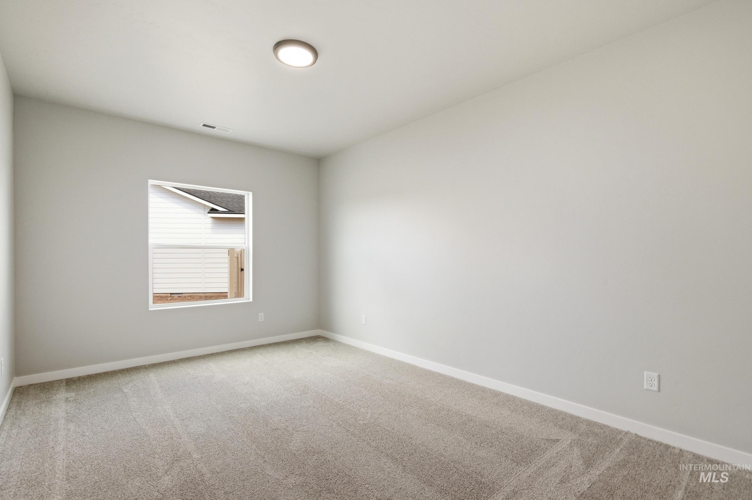509 Waverly Avenue Middleton, ID 83644 - Photo 16 of 19 Bright interior room featuring a neutral color palette, plush carpeting, and a white trim window