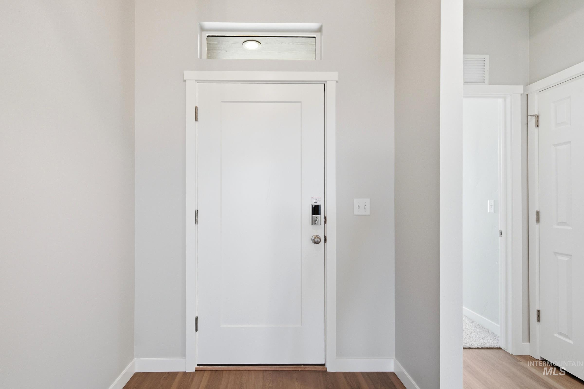 509 Waverly Avenue Middleton, ID 83644 - Photo 2 of 19 Entryway featuring a white paneled door with contemporary hardware and a transom window