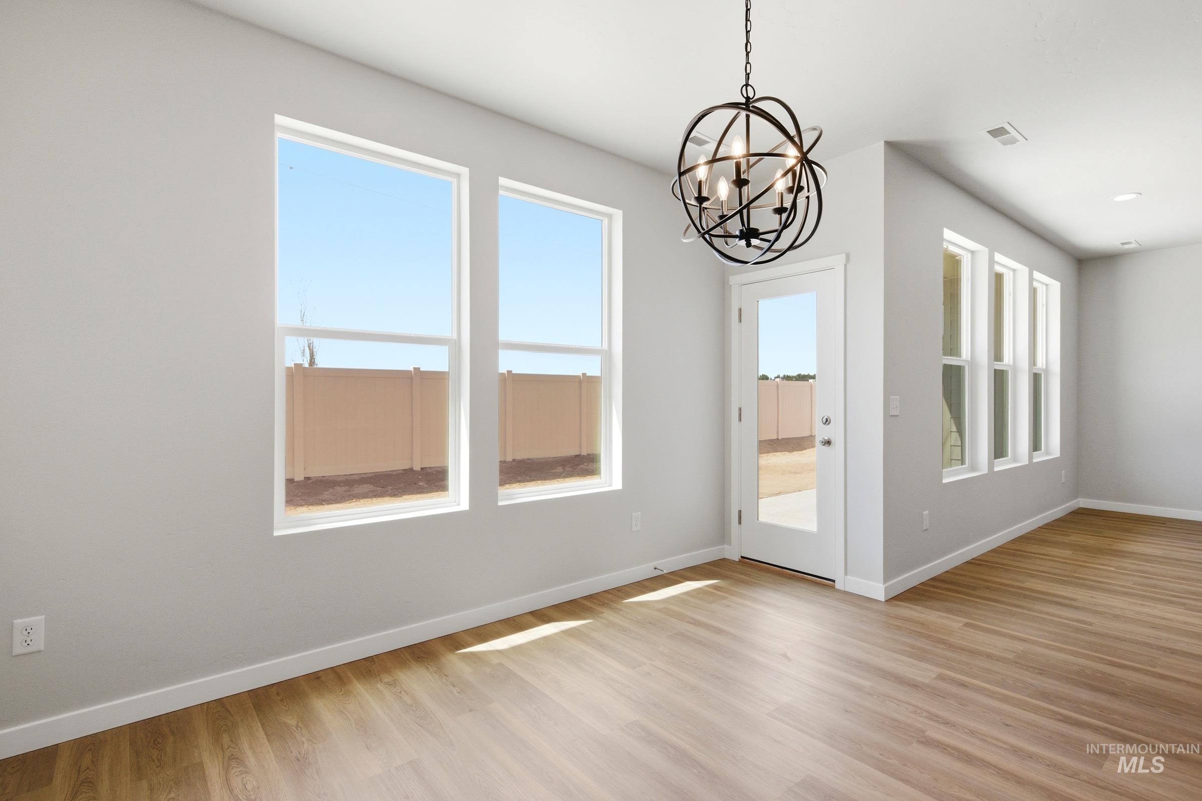 509 Waverly Avenue Middleton, ID 83644 - Photo 5 of 19 Interior room featuring wood-finish flooring, white baseboards, and light gray walls