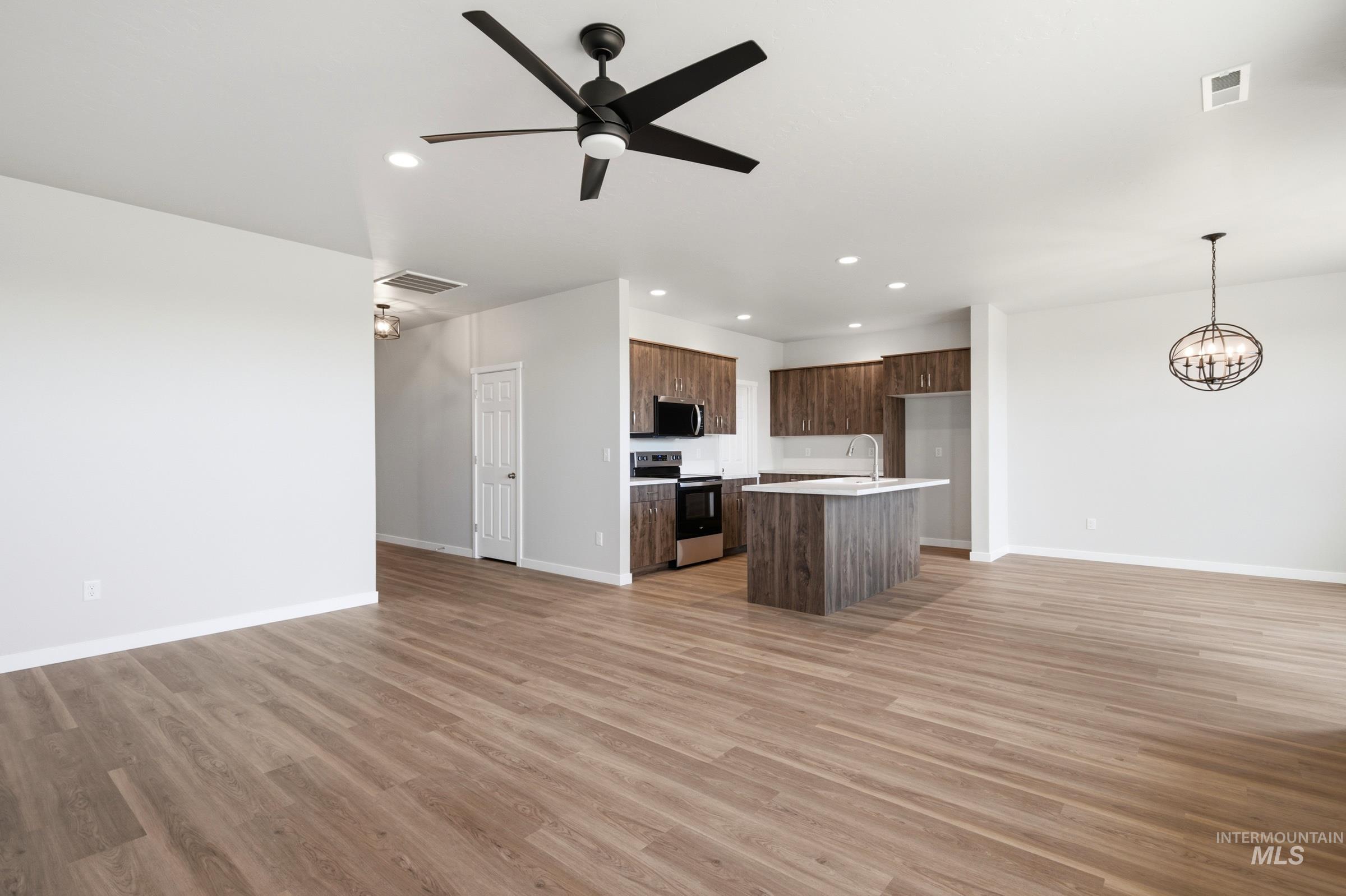 509 Waverly Avenue Middleton, ID 83644 - Photo 9 of 19 Open-concept living space featuring wood-finish flooring, a contemporary ceiling fan, and recessed lighting