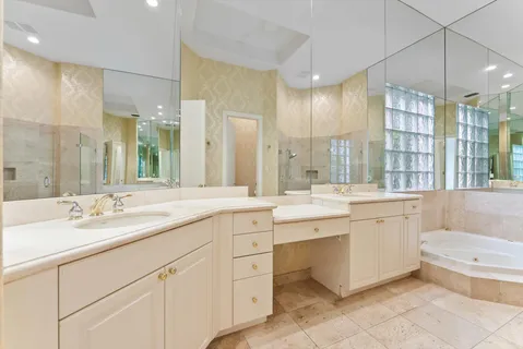 a bathroom with a double vanity sink mirror double and bathtub