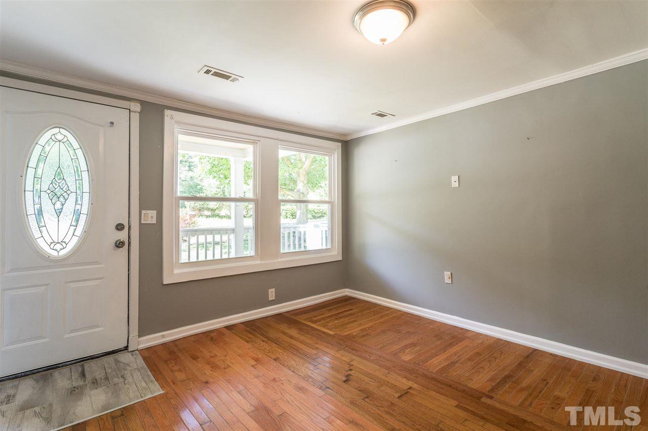 1503 Wiljohn Road Garner, NC 27529 - Photo 2 of 26 an empty room with wooden floor and windows