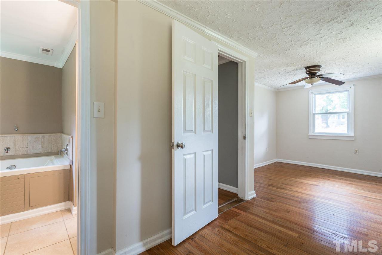 1503 Wiljohn Road Garner, NC 27529 - Photo 15 of 26 a view of an empty room with wooden floor and a window