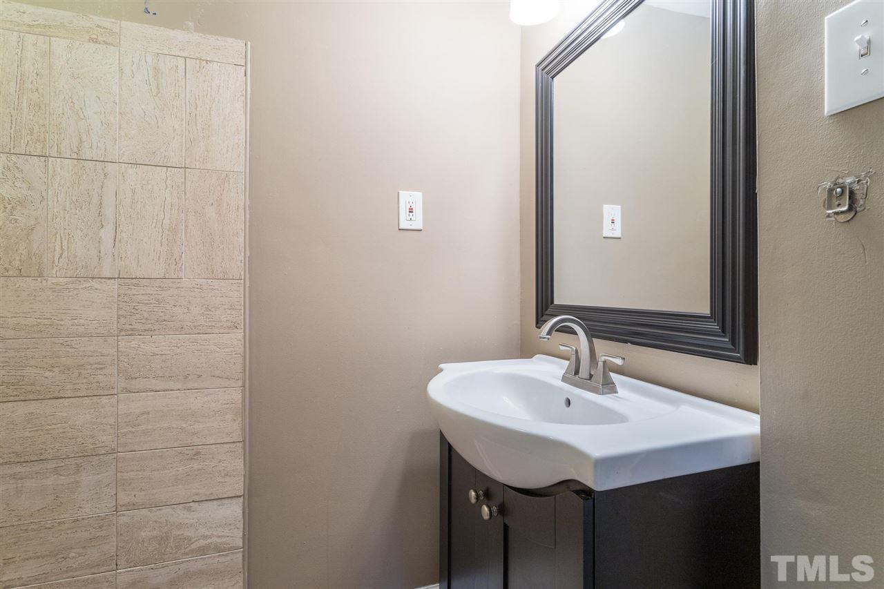 1503 Wiljohn Road Garner, NC 27529 - Photo 16 of 26 a bathroom with a sink and a mirror