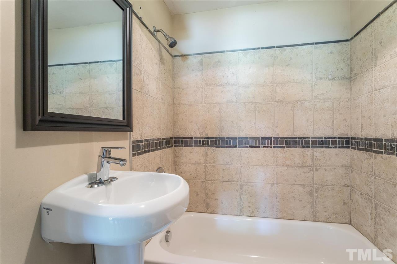 1503 Wiljohn Road Garner, NC 27529 - Photo 20 of 26 a white bath tub sitting next to a white sink