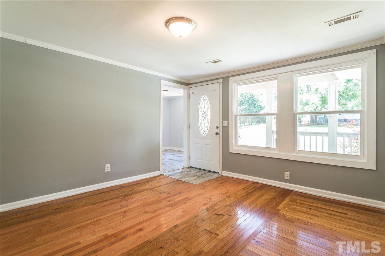 1503 Wiljohn Road Garner, NC 27529 - Photo 4 of 26 an empty room with wooden floor and windows