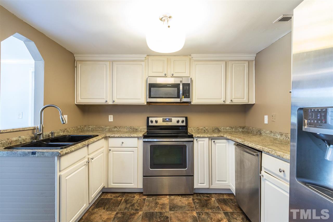 1503 Wiljohn Road Garner, NC 27529 - Photo 8 of 26 a kitchen with stainless steel appliances granite countertop a sink and a stove