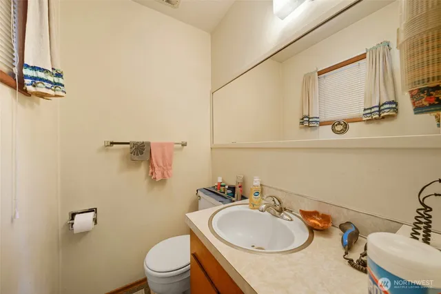 a bathroom with a sink a toilet and mirror