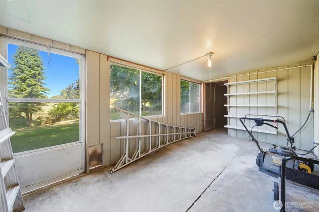 a view of a livingroom with furniture and a window