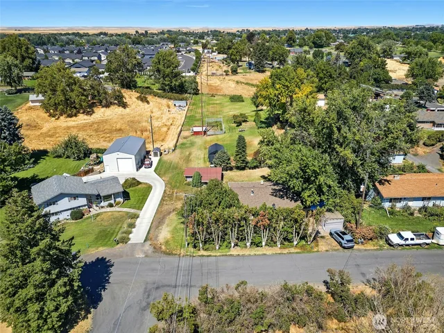 an aerial view of a house with a yard