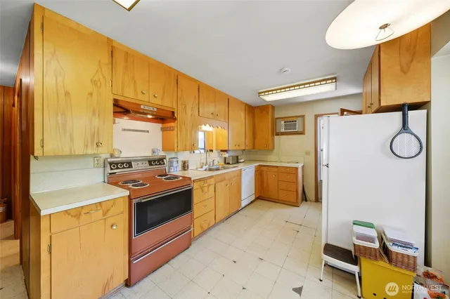 a kitchen with a sink appliances and cabinets