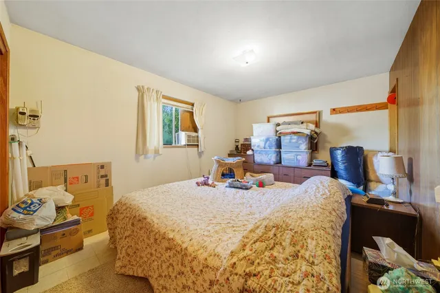 a bed room with a bed and a chair