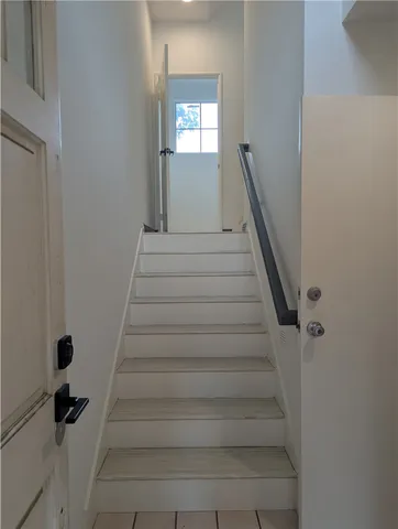 a view of a small space with wooden floor and a chandelier
