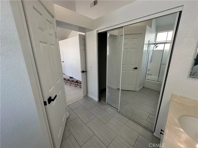 a bathroom with a double vanity sink and mirror