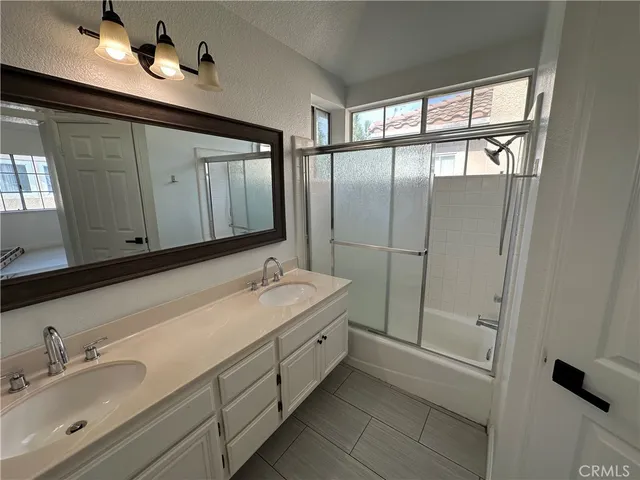 a bathroom with a sink vanity and a mirror