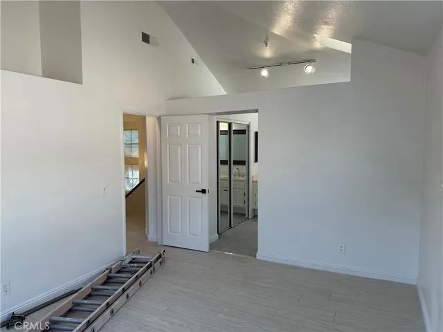 a view of an empty room with a kitchen