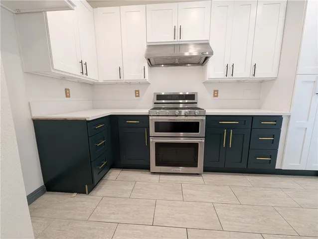 a kitchen with a stove and a sink