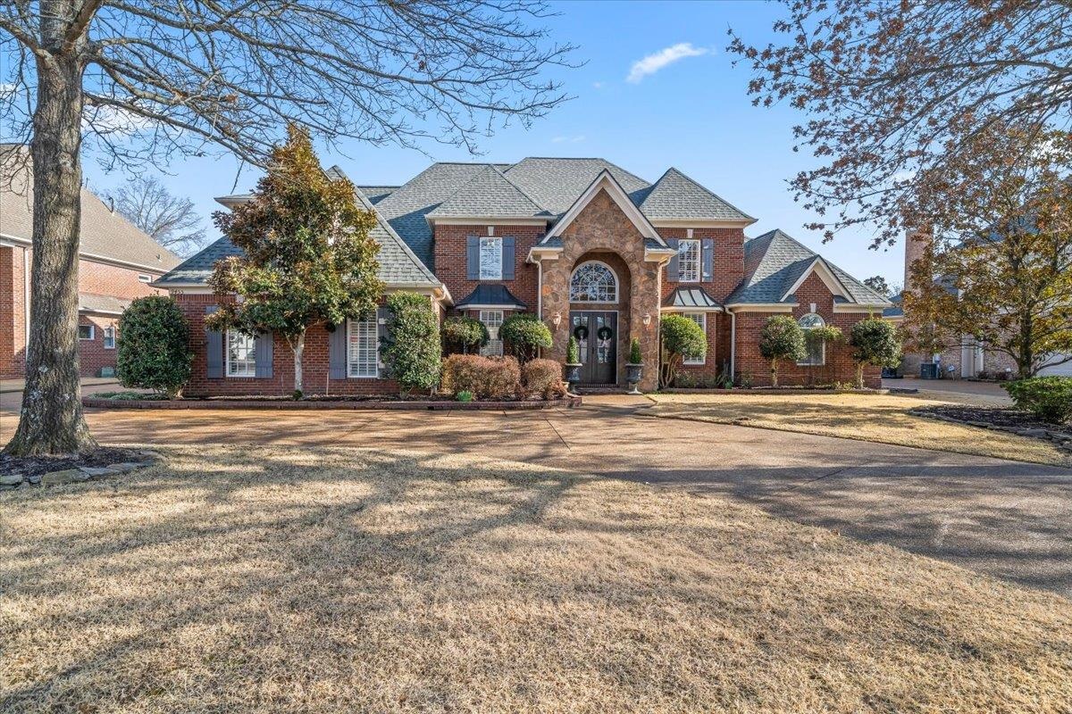 9455 Johnson Rd Extension Germantown, TN 38139 - Photo 1 of 40 Traditional home with a front lawn, brick siding, and roof with shingles