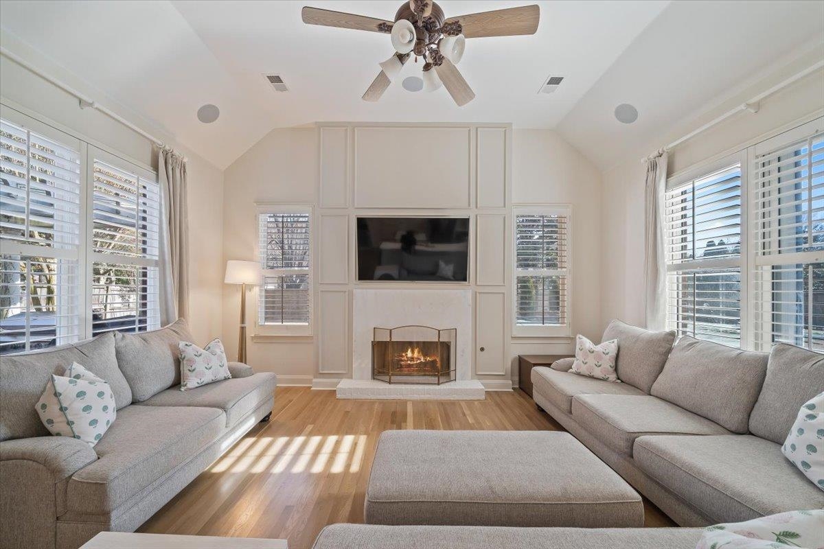 9455 Johnson Rd Extension Germantown, TN 38139 - Photo 12 of 40 Living room with a ceiling fan, vaulted ceiling, wood finished floors, healthy amount of natural light, and a premium fireplace
